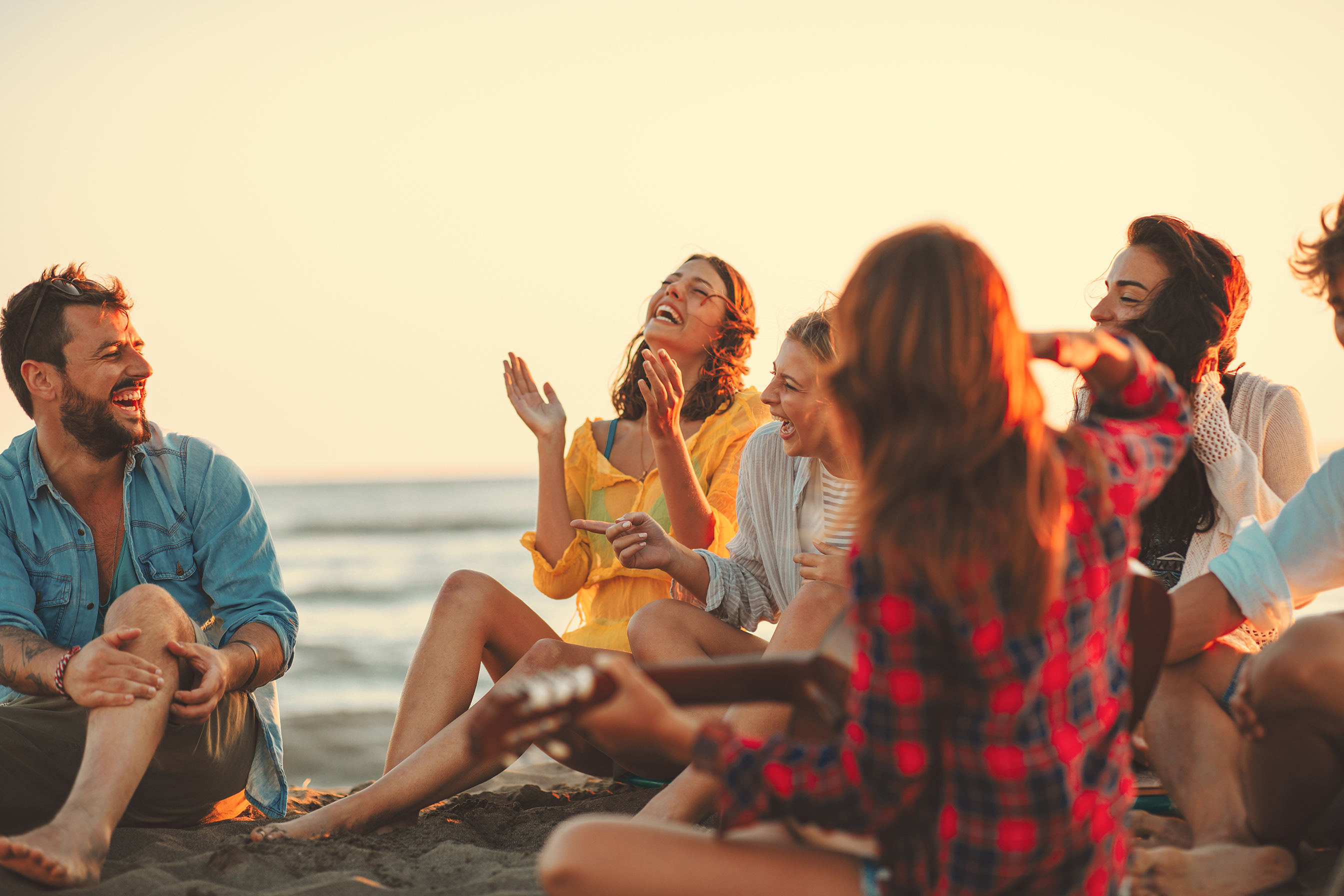 Eine Gruppe von Freunden feiert am Strand.