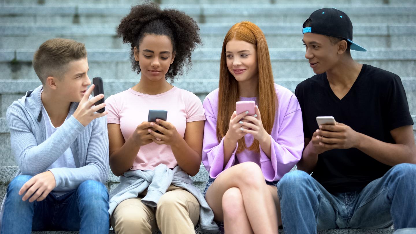 Eine Gruppe Jugendlicher mit Smartphones.