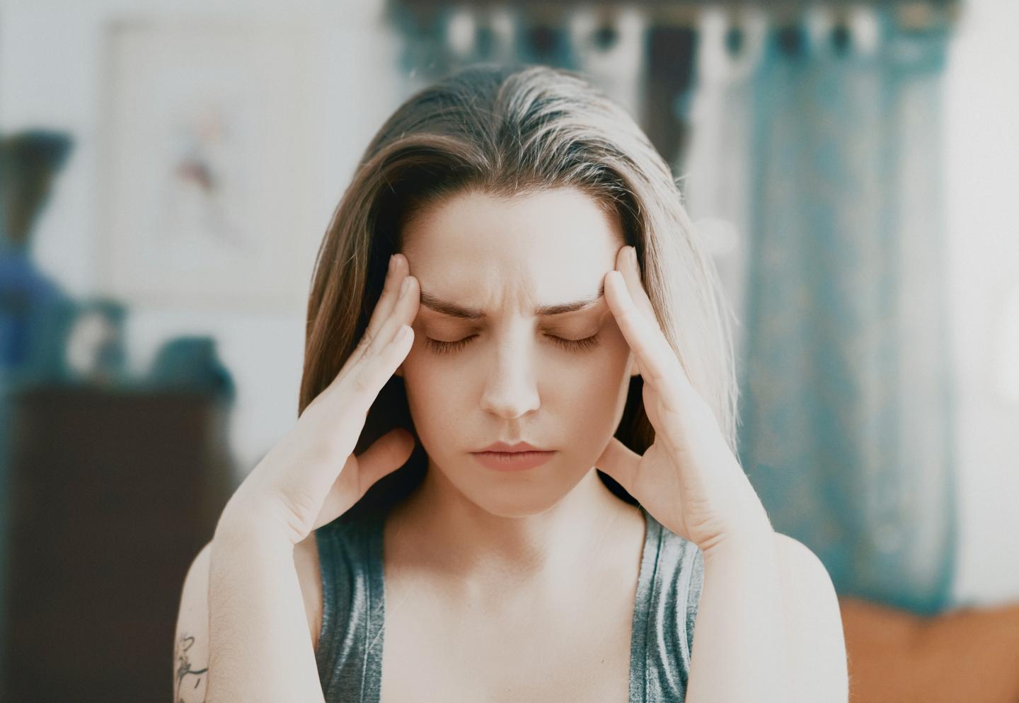 Beauty, young woman with headache at home